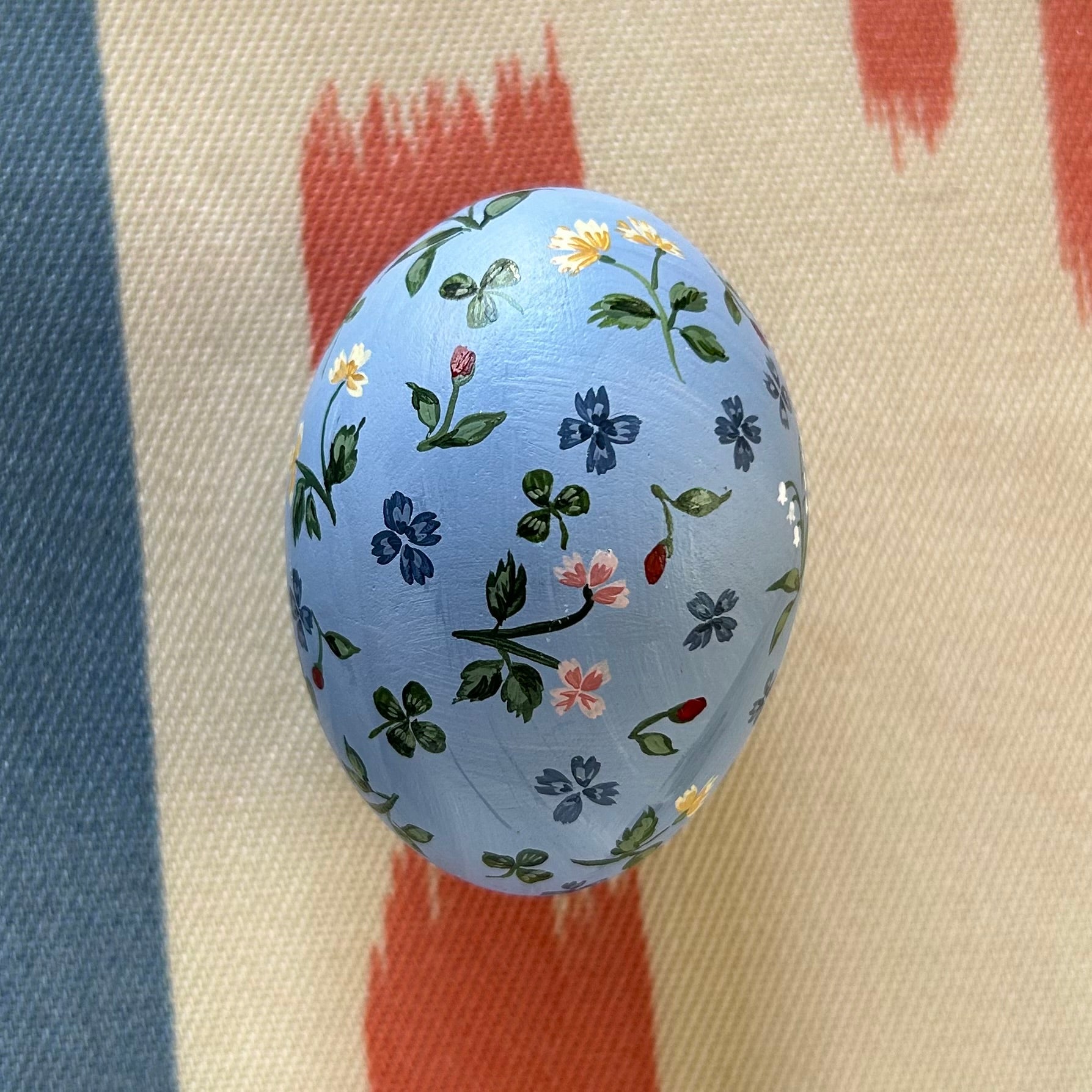 Flowers, Ladybugs, and Clovers on Blue Egg